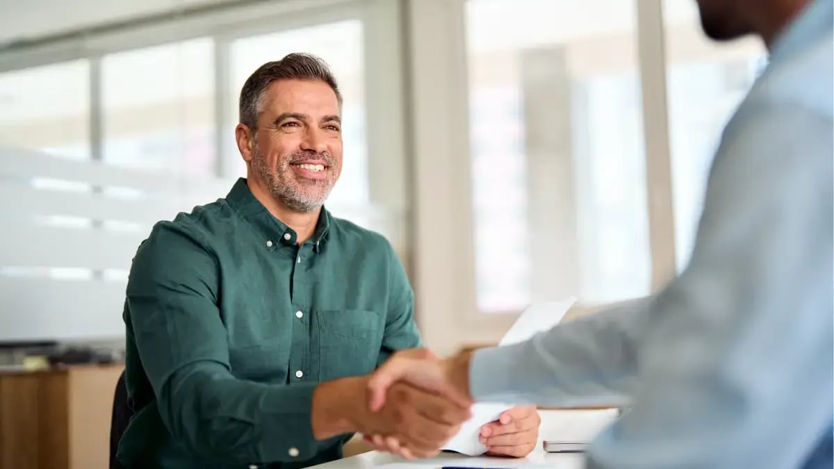 Two professionals shaking hands after a successful business agreement or interview.